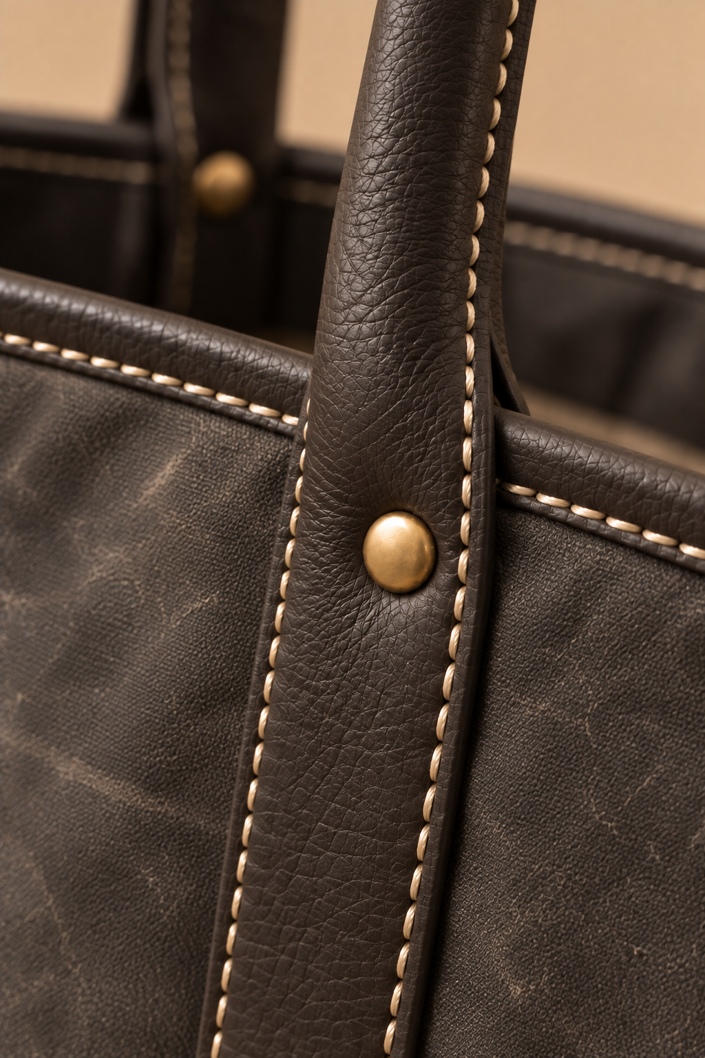 Hand stitched edge and brass rivet on the Ellis charcoal & black canvas and leather tote