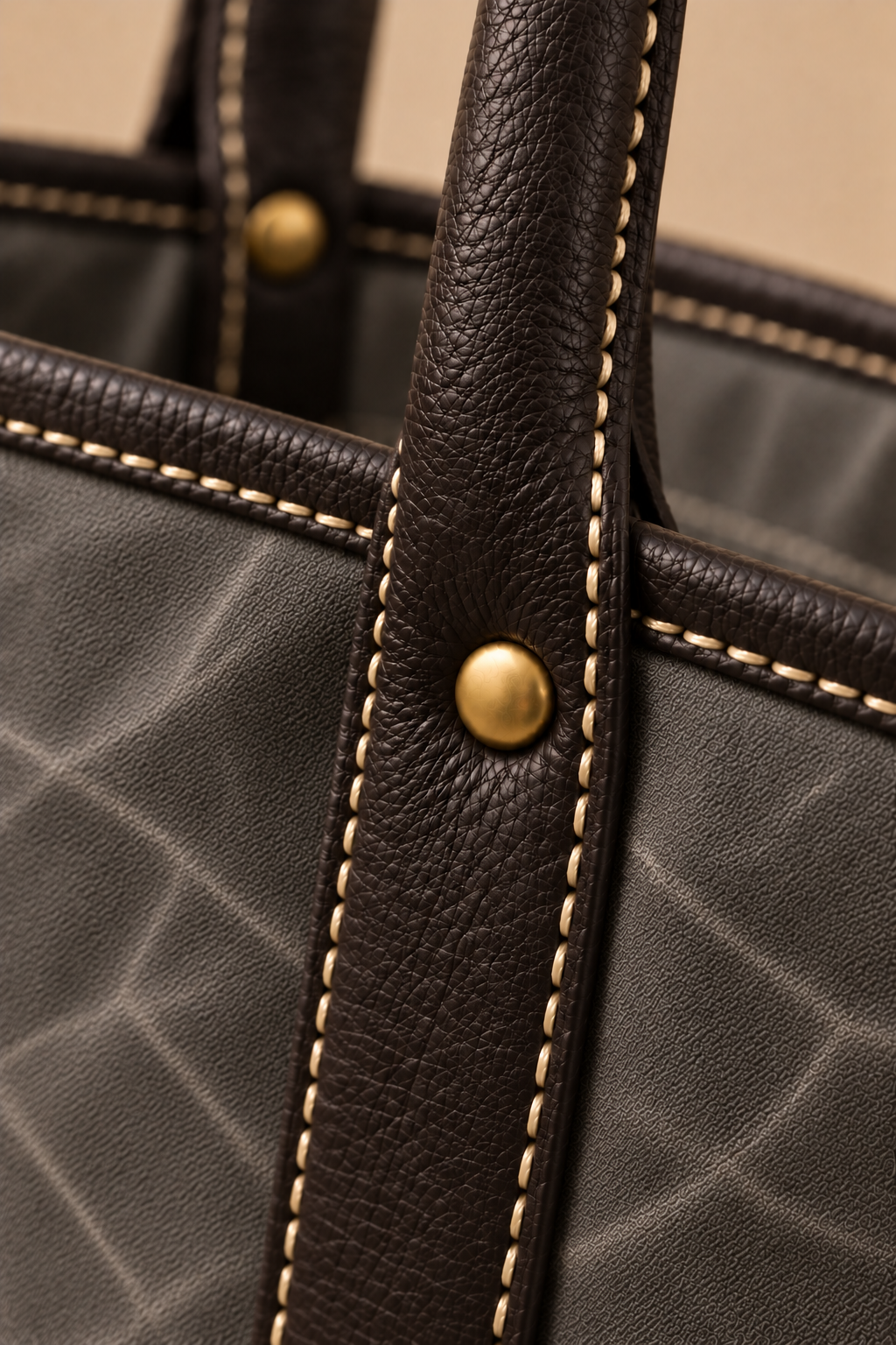 Hand stitched edge and brass rivet on the Ellis charcoal & black canvas and leather tote