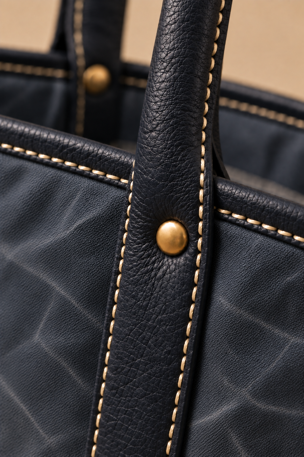 Hand stitched edge and brass rivet on the Ellis navy & chocolate canvas and leather tote