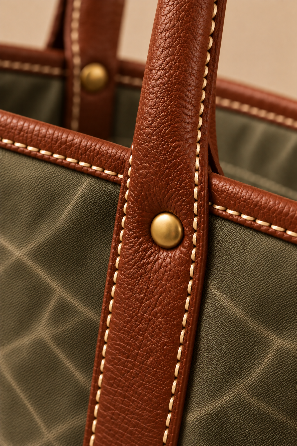 Hand stitched edge and brass rivet on the Ellis olive & tan canvas and leather tote