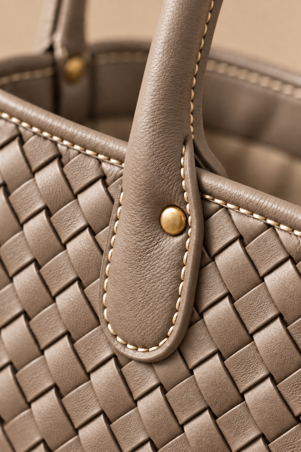 Hand stitched edge and brass rivet on the Wren stone woven leather tote