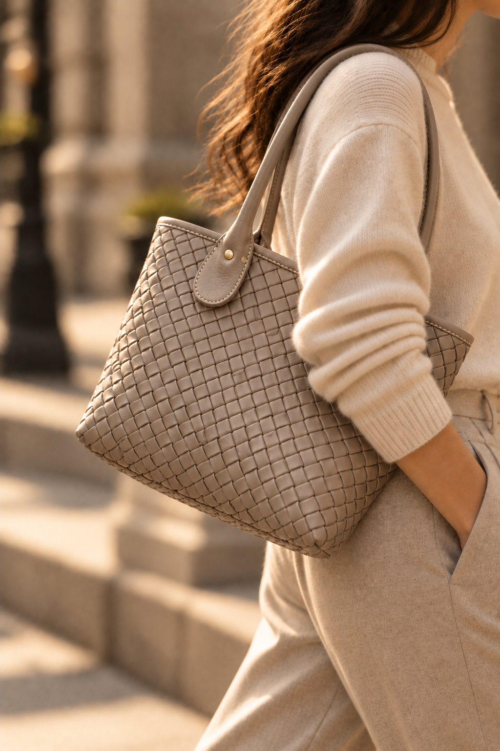 The Wren stone woven leather tote worn on the shoulder
